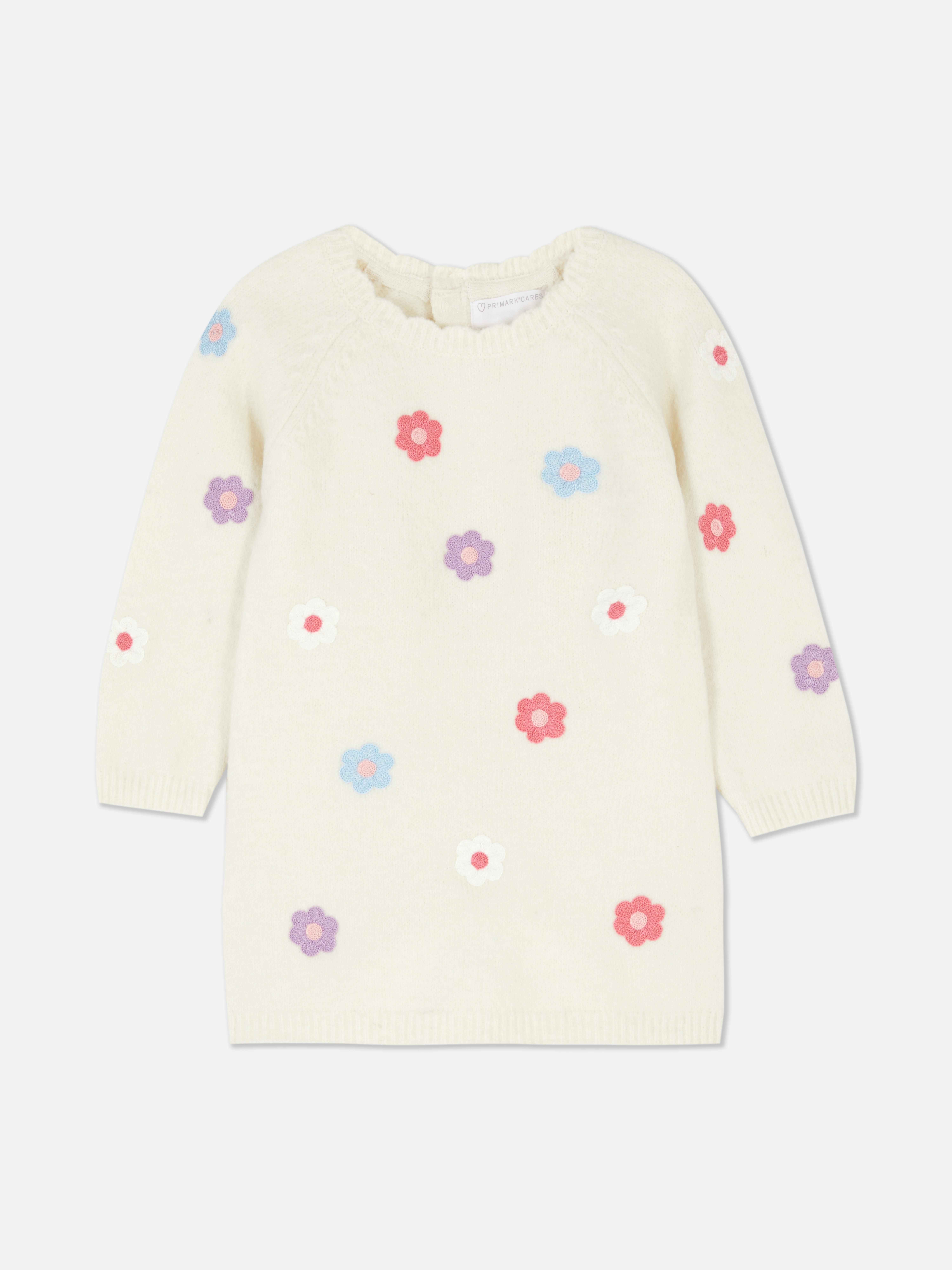 Set de șorț cu model floral și colanți. Un șorț cu model de margarete și colanți asortați.