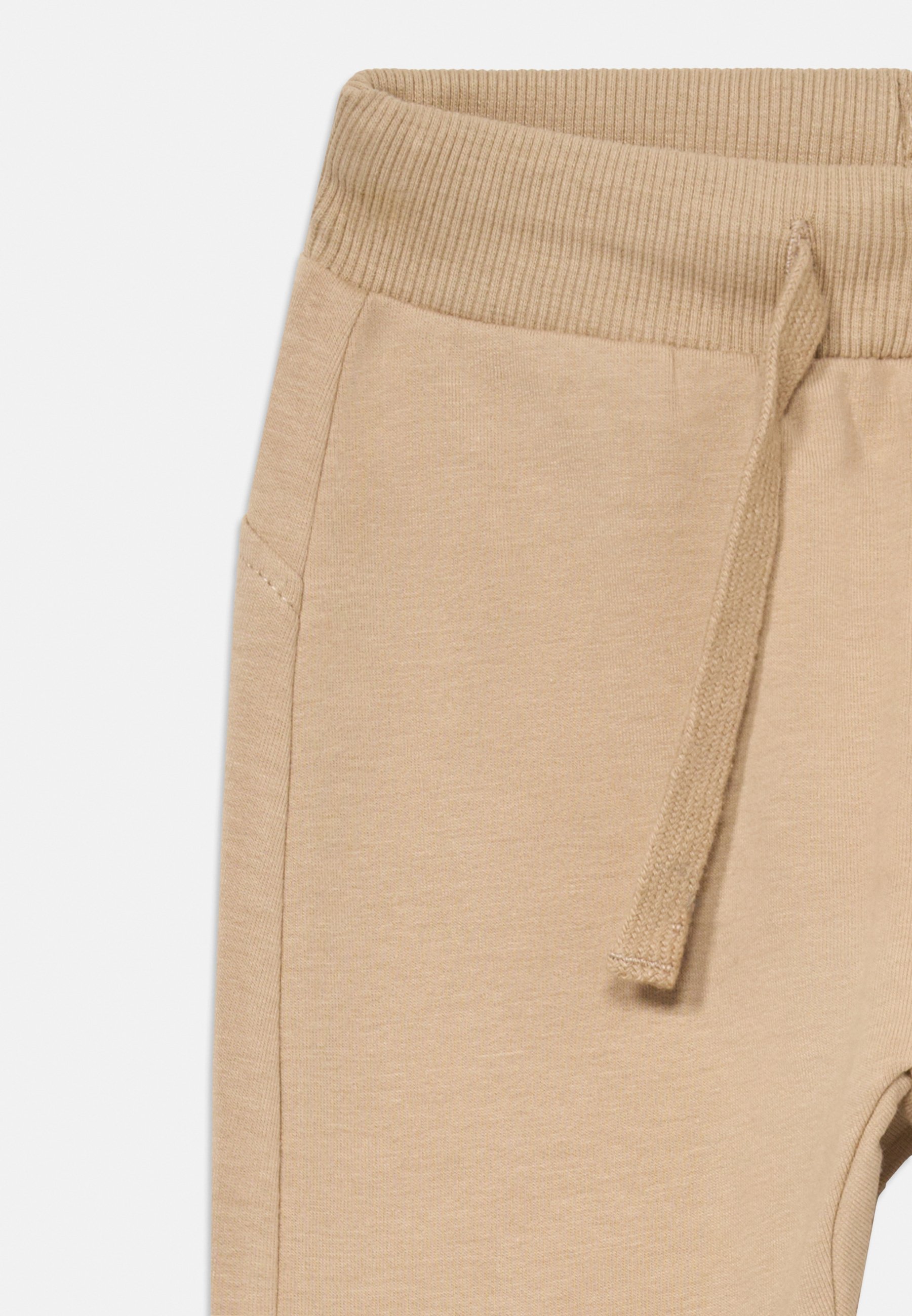 Lindex FACE AT BACK UNISEX - Trainingsbroek - beige