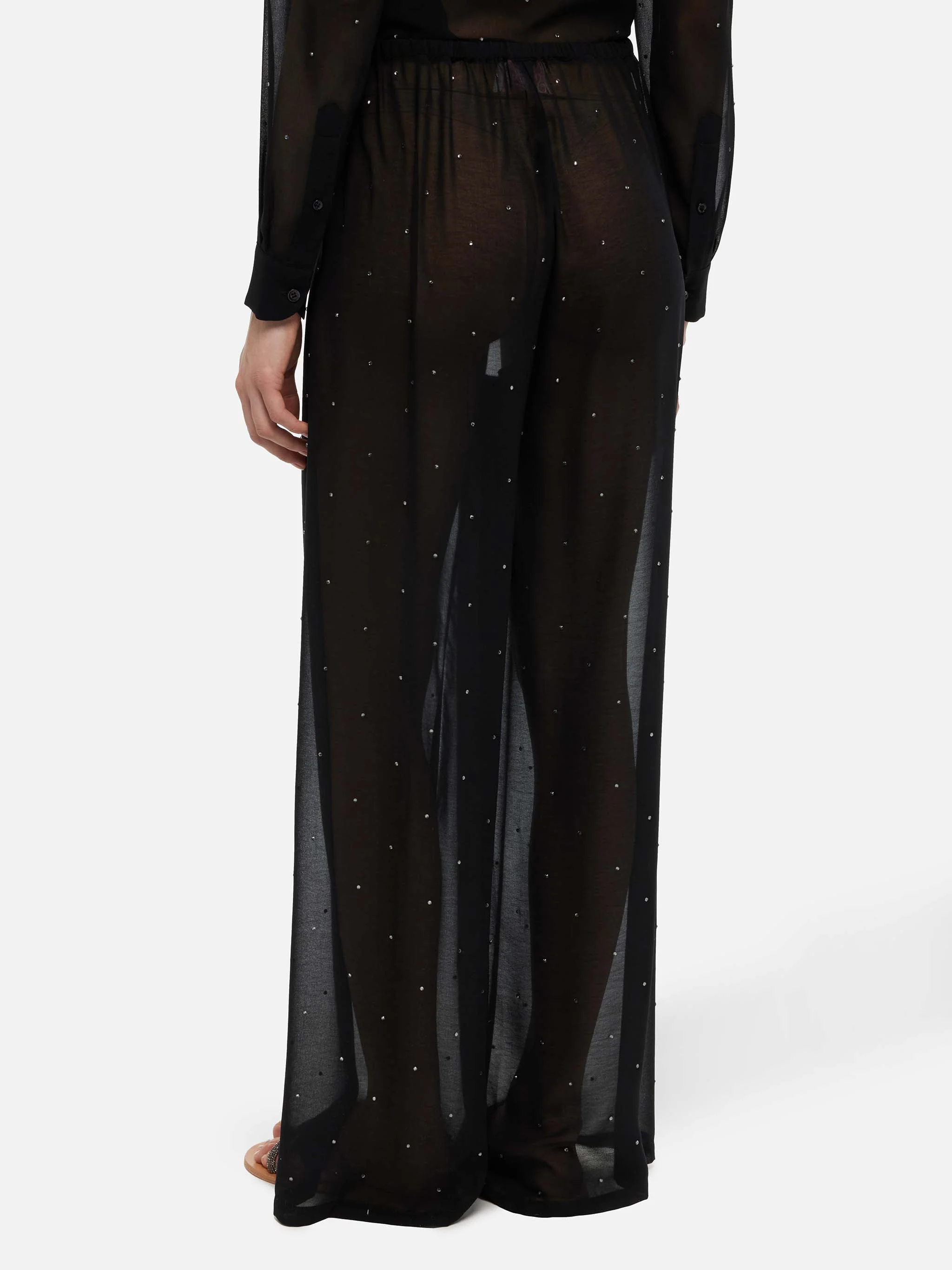 Calças Amalia de pernas largas em georgette preto com strass.