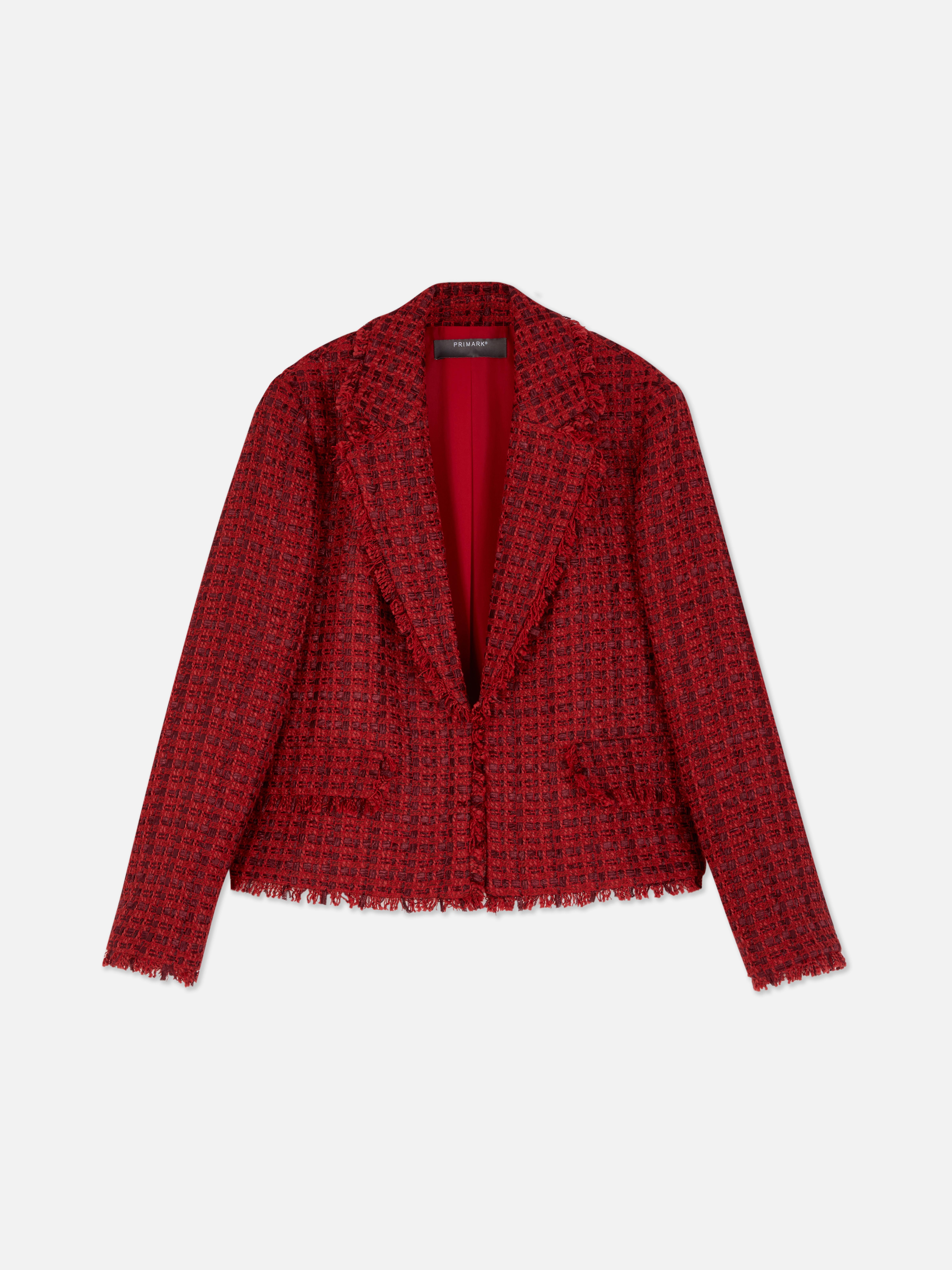 Blazer in bouclé a quadri. Un classico blazer in bouclé con revers a punta e bordi sfrangiati.