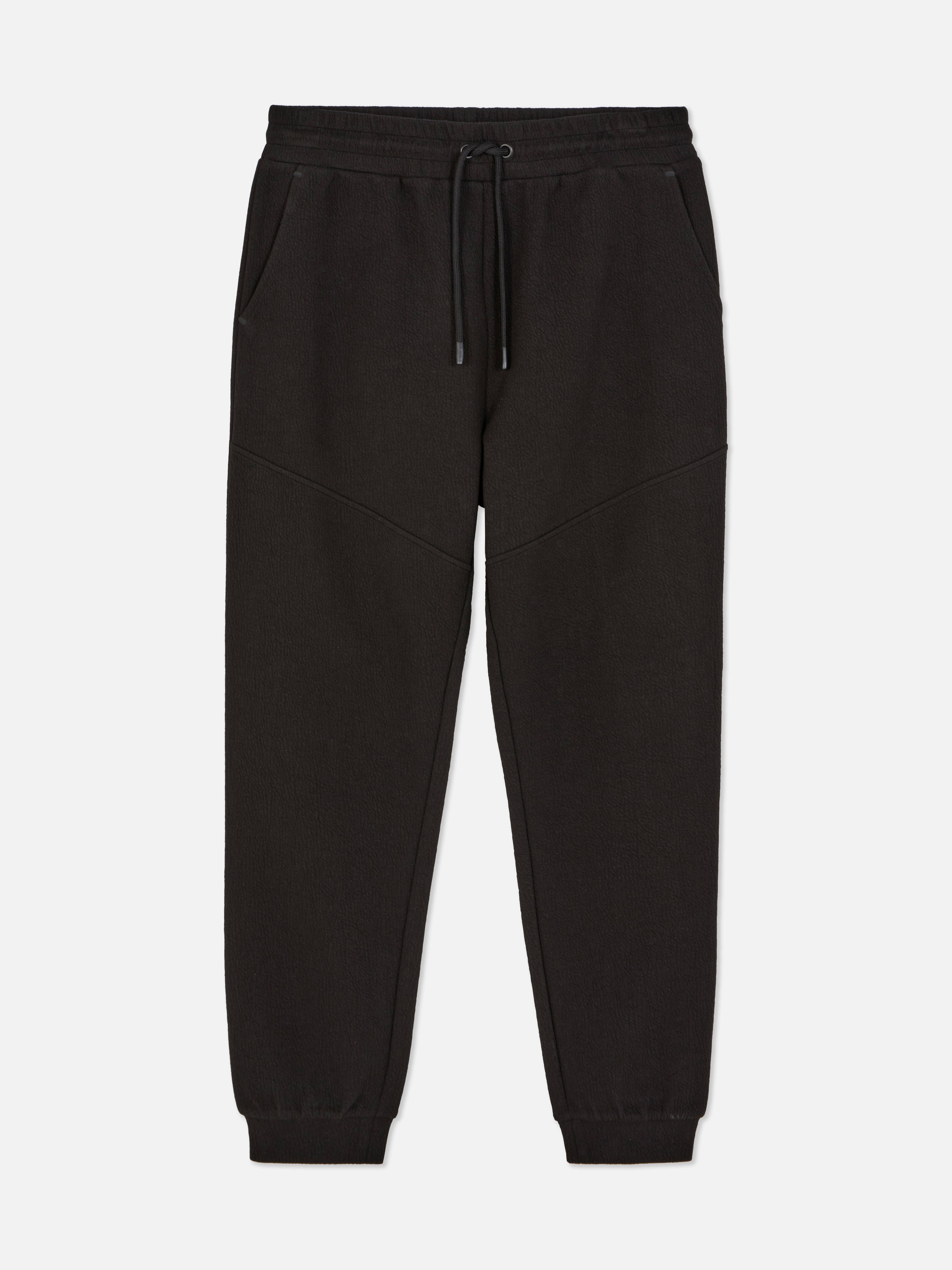 Pantaloni de trening texturați cu șnur de strângere Pantaloni de trening cu șnur de strângere, buzunare laterale, clinuri și manșete la gleznă