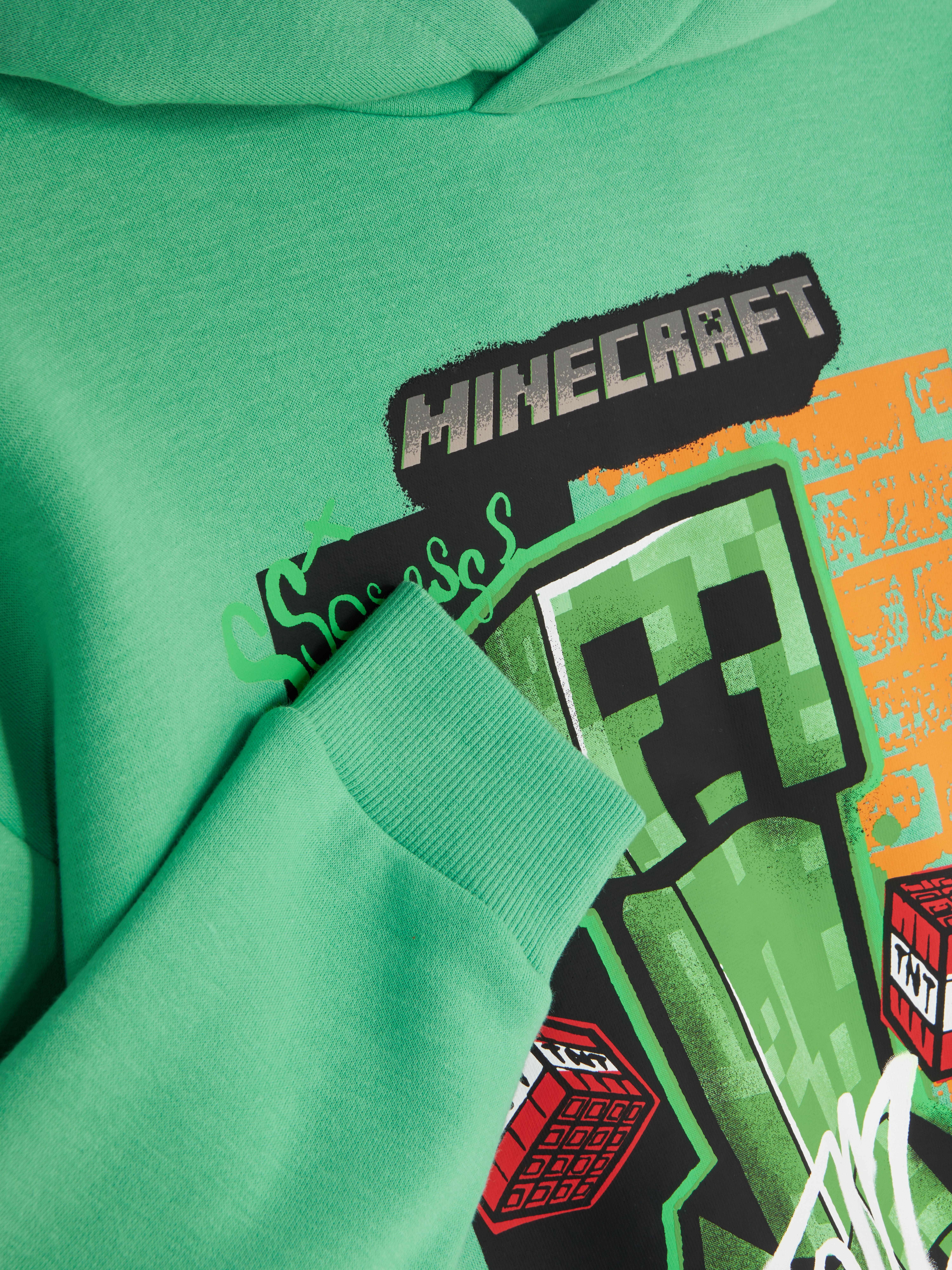 Hanorac cu imprimeu Minecraft Un hanorac cu un imprimeu Minecraft impresionant pe față