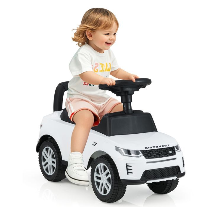 Cochecito infantil COSTWAY Land Rover con volante, claxon, sonido de motor y compartimento de almacenamiento bajo el asiento, para niños de 12 a 36 meses, hasta 25 kg, color blanco.