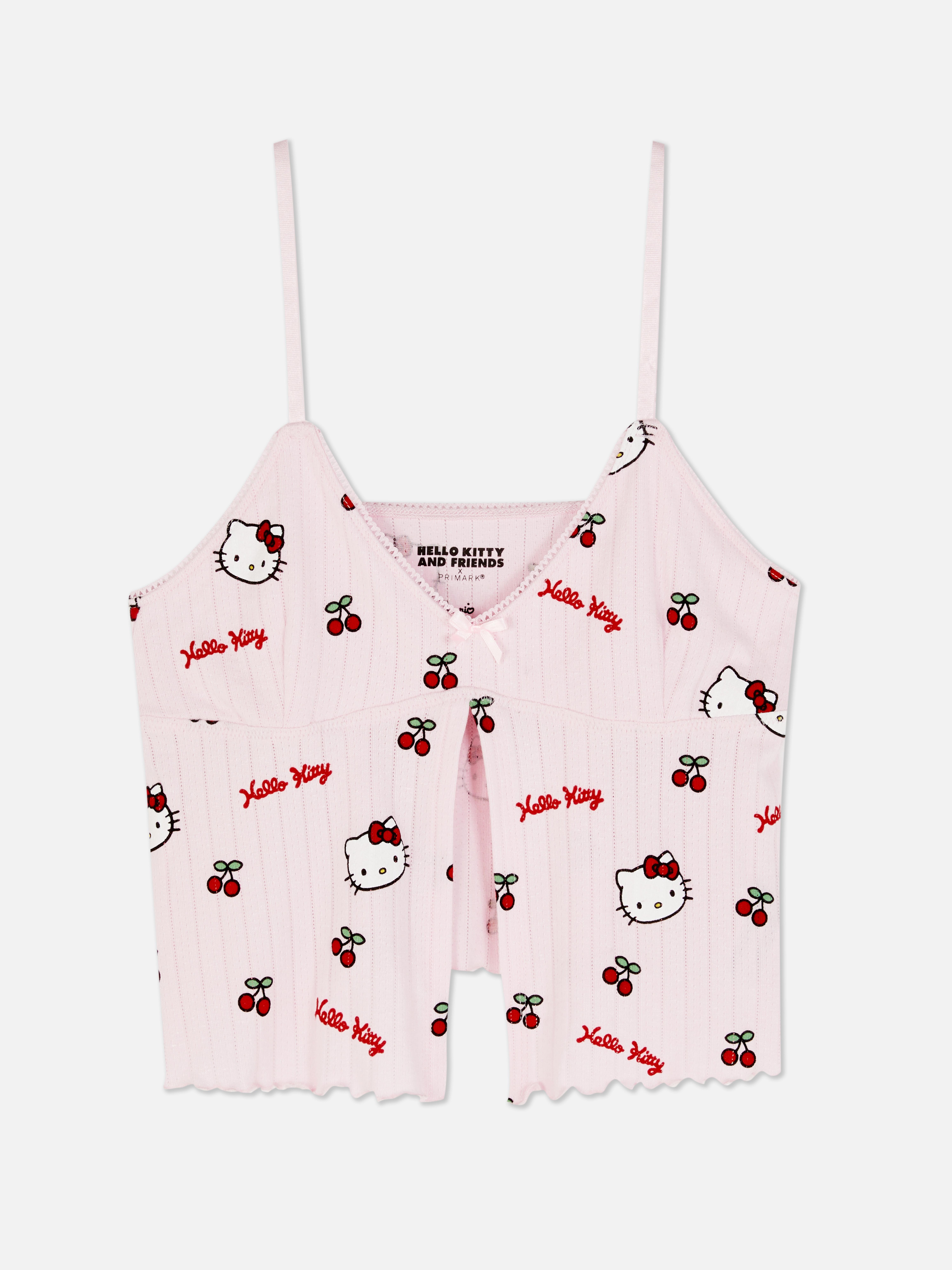 Top de pijama Hello Kitty cu imprimeu ajurat și camuflaj. Un top de pijama Hello Kitty cu ajurat, bretele reglabile, garnitură cu picot și tiv festonat.