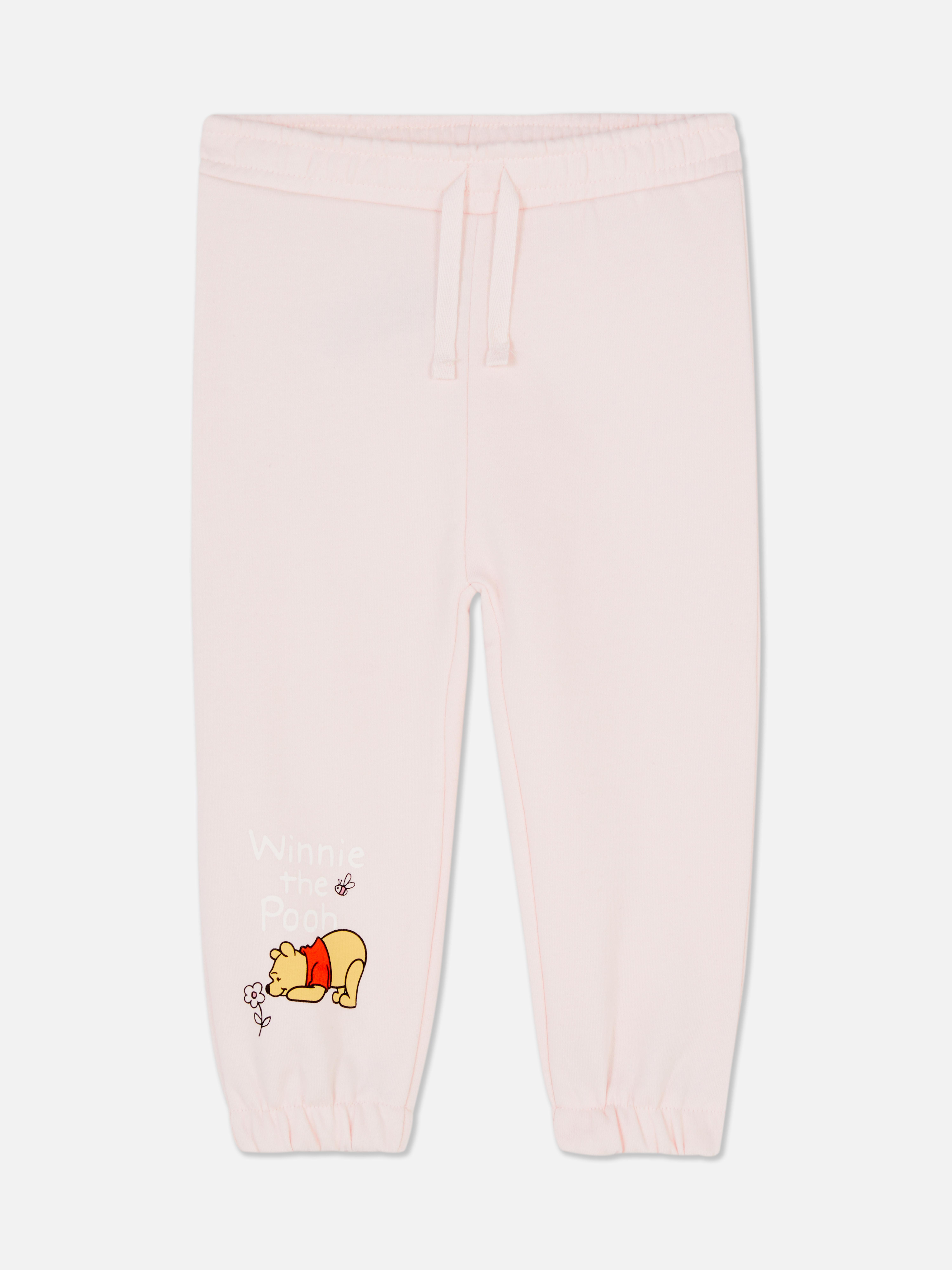 Pantaloni de trening asortați cu imprimeu Disney. Pantaloni de trening elastici cu manșete la gleznă și imprimeu Winnie the Pooh.